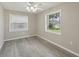 Bright bedroom with wood-look flooring, a fan, and views to the green outdoors at 4052 Marine Pkwy, New Port Richey, FL 34652
