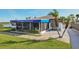 Gulf Harbors Yacht Club exterior features a screened area, outdoor seating, and palm trees at 4052 Marine Pkwy, New Port Richey, FL 34652