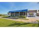 Exterior view of the Gulf Harbors Yacht Club, with a well-kept lawn and outdoor seating at 4052 Marine Pkwy, New Port Richey, FL 34652