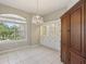 Dining area with tile floors, chandelier lighting, and built in cabinets at 4052 Marine Pkwy, New Port Richey, FL 34652