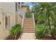 Close-up of the home's exterior highlighting stone steps and lush landscaping at 4052 Marine Pkwy, New Port Richey, FL 34652