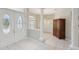 Welcoming foyer featuring tile floors, elegant entry doors, and a view into the dining area at 4052 Marine Pkwy, New Port Richey, FL 34652