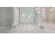 Bright foyer with tile flooring, elegant glass double doors, and decorative columns at 4052 Marine Pkwy, New Port Richey, FL 34652