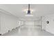 Spacious garage with white walls and floor, featuring a Chamberlain garage door opener at 4052 Marine Pkwy, New Port Richey, FL 34652