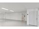 Clean, spacious garage with a utility room and white painted walls at 4052 Marine Pkwy, New Port Richey, FL 34652