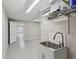 Functional laundry room with sink, cabinet, and access to additional storage space at 4052 Marine Pkwy, New Port Richey, FL 34652