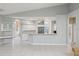 Open-concept living area featuring white cabinets, breakfast bar, and seamless flow, ideal for modern living at 4052 Marine Pkwy, New Port Richey, FL 34652