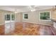 Bright living room boasts terra cotta tile, bar, ceiling fans, and sliding doors to the screened pool area at 4052 Marine Pkwy, New Port Richey, FL 34652