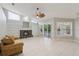 Spacious living room with fireplace, built-in shelves, sliding doors to lanai, and bright natural light at 4052 Marine Pkwy, New Port Richey, FL 34652