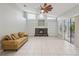Bright living room with fireplace, built-in shelves, sliding doors to lanai and vaulted ceilings at 4052 Marine Pkwy, New Port Richey, FL 34652