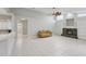 Open floor plan with a view of the kitchen, stone fireplace, built-in bookcases, and bright natural light at 4052 Marine Pkwy, New Port Richey, FL 34652