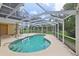 Enclosed private pool area with ample patio space and surrounding greenery at 4052 Marine Pkwy, New Port Richey, FL 34652