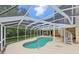 Inviting enclosed pool area features a unique shape and screened enclosure at 4052 Marine Pkwy, New Port Richey, FL 34652