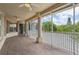 Expansive screened porch with wood-look flooring, offering serene outdoor living at 4052 Marine Pkwy, New Port Richey, FL 34652