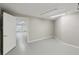 Versatile room with white trim and gray floor, accessible through a white door at 4052 Marine Pkwy, New Port Richey, FL 34652