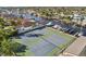 Aerial view of community tennis courts and boat docks by waterfront homes, perfect for an active coastal lifestyle at 4052 Marine Pkwy, New Port Richey, FL 34652