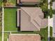 A top-down aerial shot displays the layout of the backyard, landscaping, and roof design at 4083 Woods Rider Loop, Odessa, FL 33556