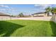 Lush green backyard with white privacy fence and mature trees, providing a serene and secluded outdoor setting at 4083 Woods Rider Loop, Odessa, FL 33556