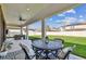 View of backyard featuring a covered patio, green lawn, and white fence providing a private outdoor space at 4083 Woods Rider Loop, Odessa, FL 33556