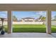 View of backyard framed by patio supports highlighting the green lawn and privacy fence at 4083 Woods Rider Loop, Odessa, FL 33556