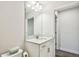 Bright bathroom featuring a vanity with white cabinets, a mirror, and a toilet at 4083 Woods Rider Loop, Odessa, FL 33556