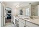 Bathroom featuring double vanity sinks, white cabinets, tile floors, and an ensuite bedroom at 4083 Woods Rider Loop, Odessa, FL 33556