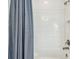 Bright bathroom showcasing white tile, bathtub, and a shower with bronze fixtures at 4083 Woods Rider Loop, Odessa, FL 33556
