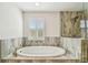 Bathroom with walk-in shower and soaking tub at 4083 Woods Rider Loop, Odessa, FL 33556