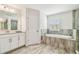 Bright bathroom with soaking tub, shower, and stylish vanity at 4083 Woods Rider Loop, Odessa, FL 33556