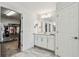 Bathroom with walk in closet and a double sink vanity at 4083 Woods Rider Loop, Odessa, FL 33556