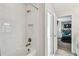 Bright bathroom featuring white tile, bathtub and shower combo, and bronze fixtures at 4083 Woods Rider Loop, Odessa, FL 33556