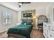 Bedroom features stylish decor, a ceiling fan, and a window providing bright natural light at 4083 Woods Rider Loop, Odessa, FL 33556