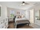 Bright bedroom featuring ceiling fan, neutral tones, and a window providing ample natural light at 4083 Woods Rider Loop, Odessa, FL 33556