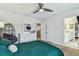 Stylish bedroom features ceiling fan, television, and ensuite bathroom for convenience at 4083 Woods Rider Loop, Odessa, FL 33556