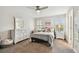 Bright bedroom features neutral tones, ceiling fan, and a large window with bright natural light at 4083 Woods Rider Loop, Odessa, FL 33556
