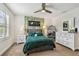 Bedroom featuring stylish decor, neutral tones, and bright natural light from the window at 4083 Woods Rider Loop, Odessa, FL 33556