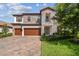 Beautiful two-story home featuring stone accents, a three-car garage, and landscaped front yard at 4083 Woods Rider Loop, Odessa, FL 33556