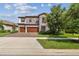 Beautiful two-story home featuring stone accents, a three-car garage, and landscaped front yard at 4083 Woods Rider Loop, Odessa, FL 33556