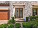 Inviting front entrance features double doors, stone accents, and lush landscaping at 4083 Woods Rider Loop, Odessa, FL 33556