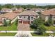 Attractive two-story home featuring a stone facade, a two-car garage, and manicured landscaping at 4083 Woods Rider Loop, Odessa, FL 33556