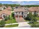 Elegant two-story home with a stone facade, two-car garage, and a well-manicured lawn at 4083 Woods Rider Loop, Odessa, FL 33556