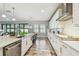 Gourmet kitchen with white cabinetry, tile backsplash, and a center island overlooking the backyard at 4083 Woods Rider Loop, Odessa, FL 33556