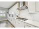 Modern kitchen features white cabinetry, stainless steel appliances, and sleek countertops at 4083 Woods Rider Loop, Odessa, FL 33556