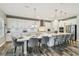 Bright, open-concept kitchen with white cabinets, stainless appliances, and center island with seating at 4083 Woods Rider Loop, Odessa, FL 33556