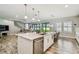 Spacious kitchen with an island featuring seating, stainless appliances, and an open layout to the living area at 4083 Woods Rider Loop, Odessa, FL 33556