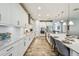 Stylish kitchen features white cabinets, subway tile backsplash, stainless appliances and island with dining space at 4083 Woods Rider Loop, Odessa, FL 33556