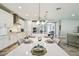 Modern kitchen featuring white cabinets, stainless steel appliances, and an island with dining space at 4083 Woods Rider Loop, Odessa, FL 33556