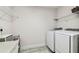 Bright laundry room features a modern washer/dryer and ample storage shelves at 4083 Woods Rider Loop, Odessa, FL 33556