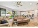Open-concept floor plan seamlessly connects the living room, with its hardwood floors, to the white kitchen area at 4083 Woods Rider Loop, Odessa, FL 33556