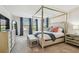 Spacious main bedroom featuring a canopy bed, plush carpet, and elegant furnishings at 4083 Woods Rider Loop, Odessa, FL 33556